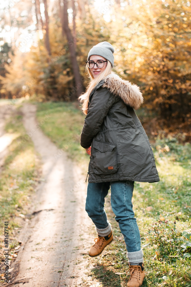 Hiking and travel along in the forest. Concept of trekking, adventure and seasonal vacation. Young woman walking in woods. Hiking and travel along in the forest. Concept of trekking, adventure and seasonal vacation. Young woman walking in woods.