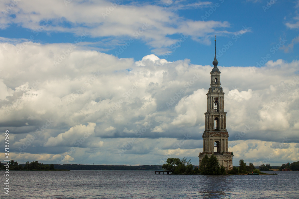 A bell tower submerged in the river in Kalyazin Russia against a cloudy dramatic sky and space for copying