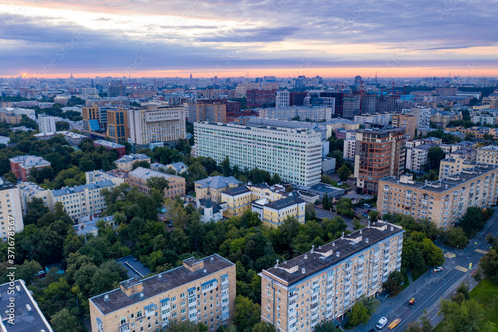 green park and houses at dawn view from drone