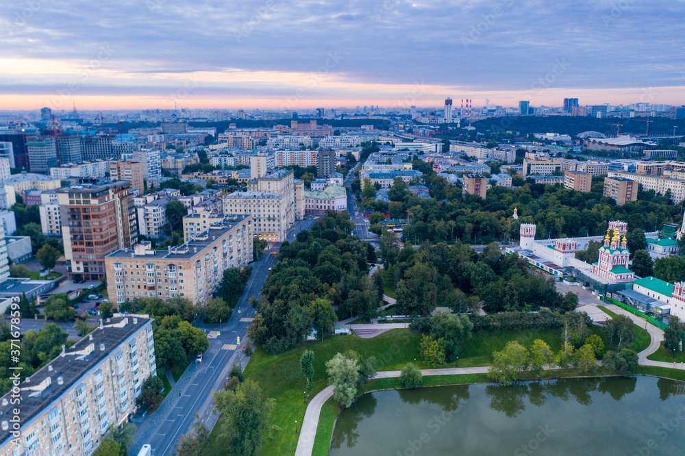 green park and houses at dawn view from drone