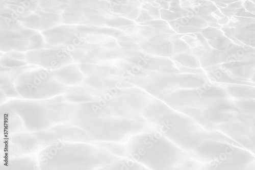 Desaturated transparent clear calm water surface texture with splashes and bubbles. Trendy abstract nature background. 
