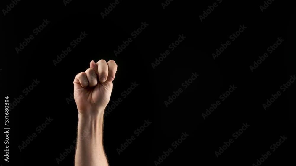 Male hand showing letter N on dark background. Sign language alphabet