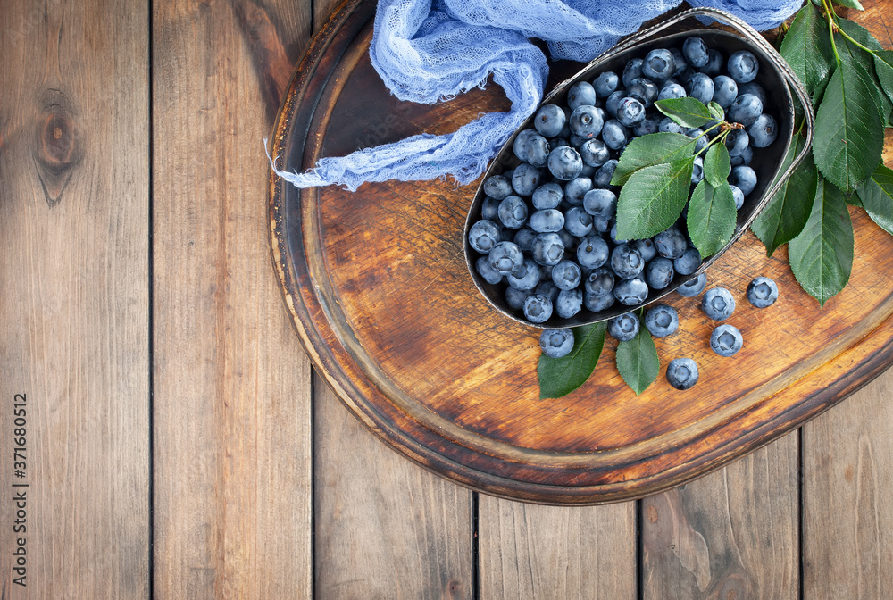 Blueberries in a plate and pancakes, on an old background. Blueberries in a plate and pancakes, on an old background.