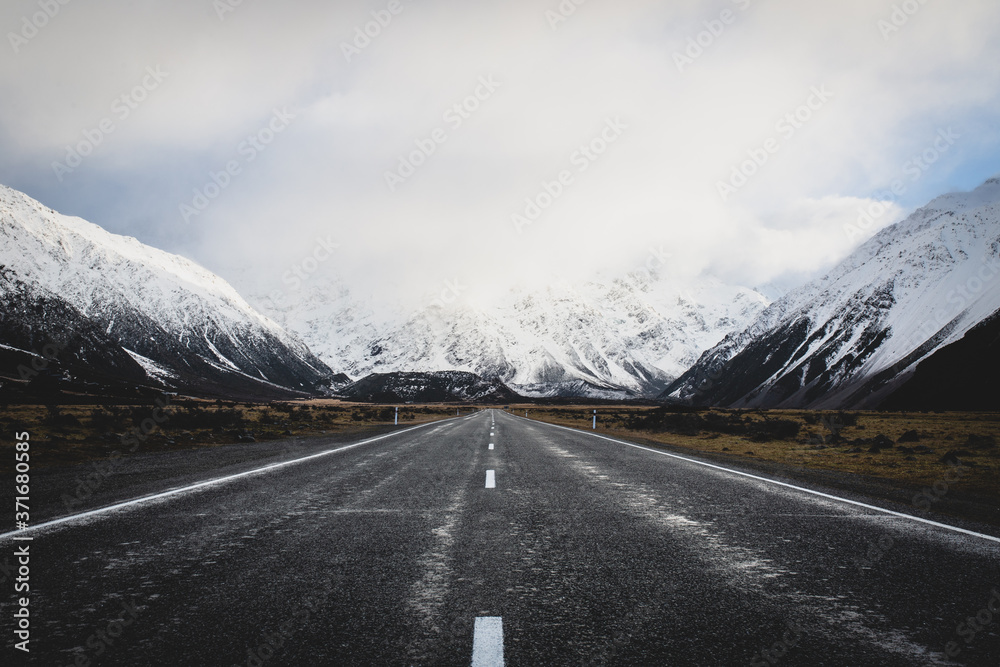 The Road to Hooker Valley, South Island, New Zealand with Snowy Mountains and Low Hanging Clouds
