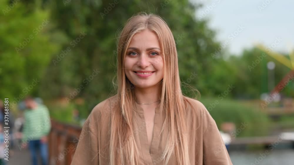 Portrait of a happy young girl with white hair walking in the fresh air. Smiling positive millennial girl looking at camera. Healthy Lifestyle Concept. Portrait of a happy young girl with white hair walking in the fresh air. Smiling positive millennial girl looking at camera. Healthy Lifestyle Concept.