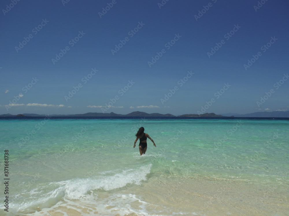 Walk into water tanned woman beach paradise Walk into water tanned woman beach paradise