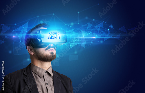 Businessman looking through Virtual Reality glasses with SERVER SECURITY inscription, cyber security concept