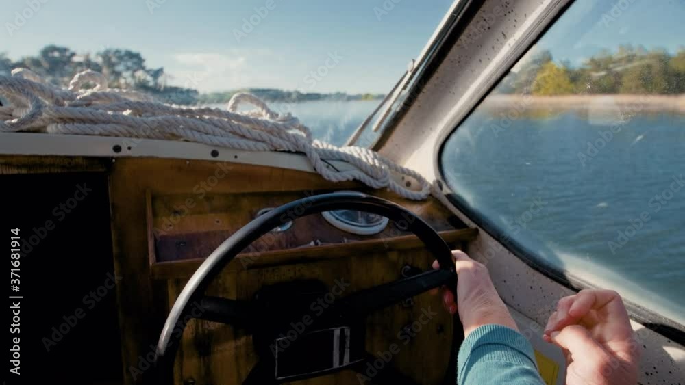 Close up of woman elderly girl hands turning a ship sail boat motor vessel steering wheel to the right on the blue sea ocean on a sunny summers day slowly turning the boat changing course small yacht Close up of woman elderly girl hands turning a ship sail boat motor vessel steering wheel to the right on the blue sea ocean on a sunny summers day slowly turning the boat changing course small yacht