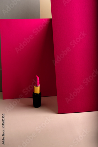 Pink lipstick on modern minimalist background, concept of makeup photo