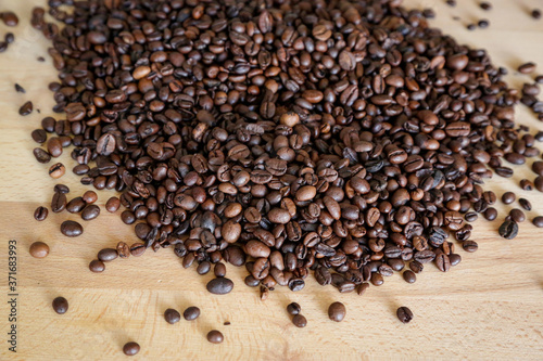 Coffee grains on wooden table, with natural light © theblondegirl12