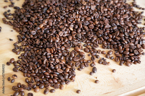 Coffee grains on wooden table, with natural light © theblondegirl12