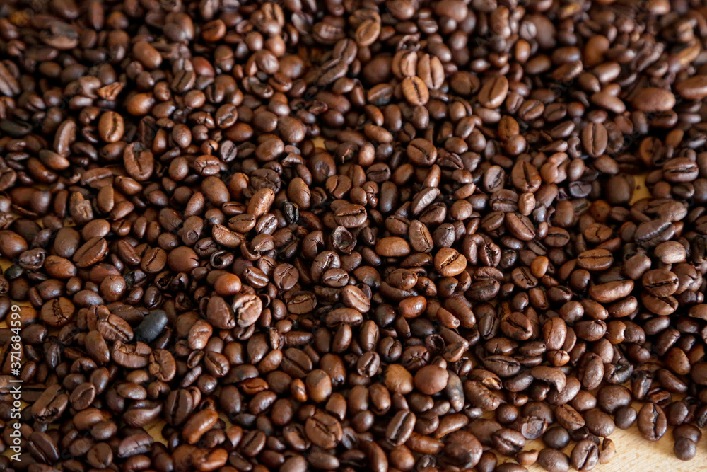 Coffee grains on wooden table, with natural light Coffee grains on wooden table, with natural light