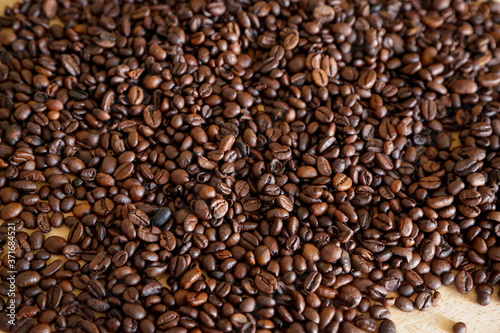 Coffee grains on wooden table  with natural light