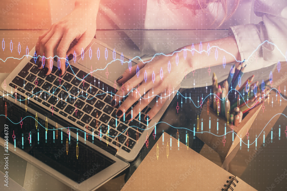 Double exposure of woman hands typing on computer and forex chart hologram drawing. Stock market invest concept.