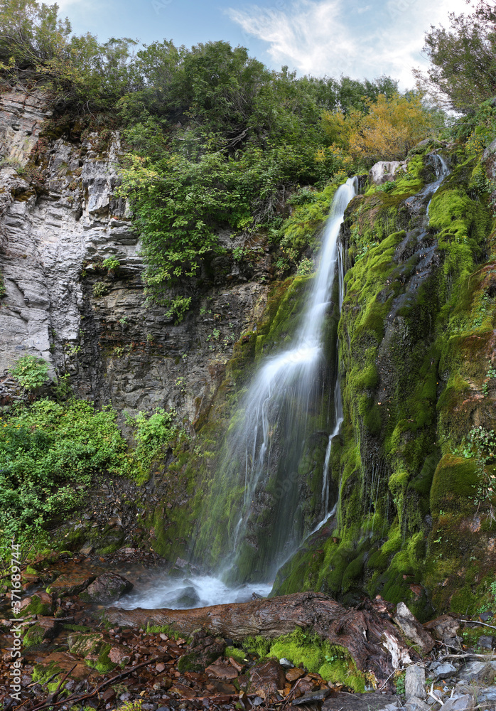 A waterfall no one has visited but me cascades down the side of mount timpanogos in Utah.