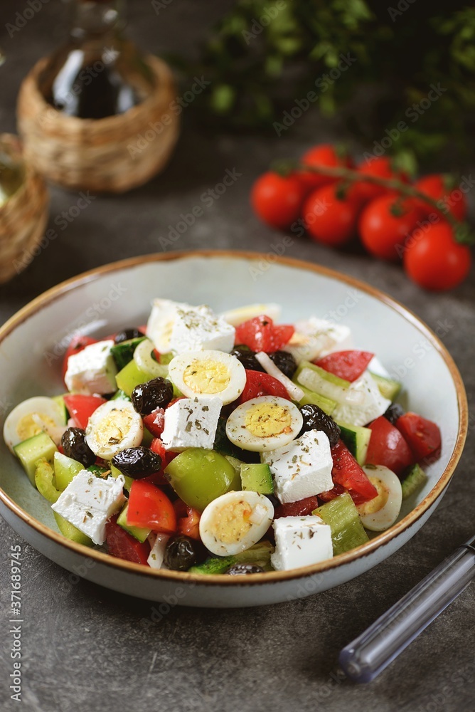 Greek salad with quail eggs. Salad with peppers, tomatoes, cucumbers, feta, oregano, olives, onions, olive oil and lemon juice. Greek salad with quail eggs. Salad with peppers, tomatoes, cucumbers, feta, oregano, olives, onions, olive oil and lemon juice.