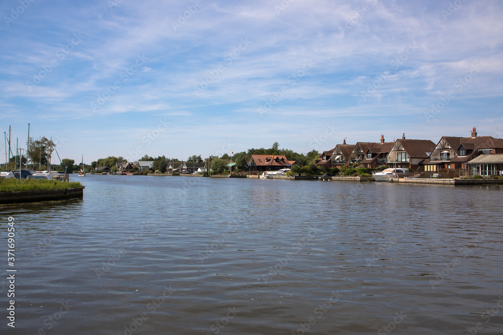 The River Bure passing through the ancient village of Horning, The Broads, Norfolk, UK