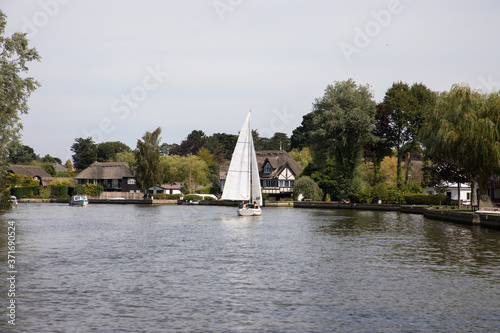 The River Bure passing through the ancient village of Horning, The Broads, Norfolk, UK