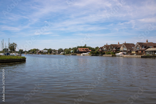 The River Bure passing through the ancient village of Horning, The Broads, Norfolk, UK