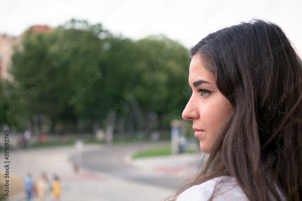 Teenager looking at camera relaxed with a panorama of the city in the background. Teenager looking at camera relaxed with a panorama of the city in the background.