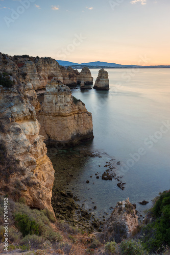 Landscape with the rocks of Ponta da Piedade at sunrise near Lagos and Luz at Algarve, Portugal