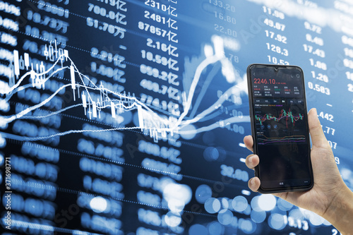 Holding a mobile phone to see stocks and stock securities trading data analysis