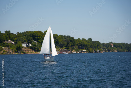 A sail boat on a river on a sunny, summers day