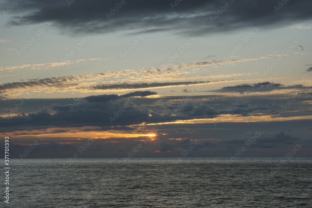 Sunset. Beautiful sunset at Japanese sea. Gold sea sunset. Picture Sea sunset.