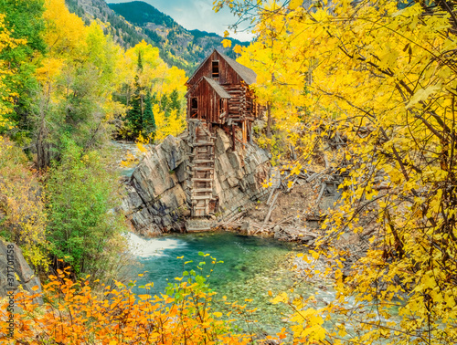 Crystal Mill, an abandoned  powerhouse is surrounded by fall aspens of the Gunnison National Forest in Colorado.