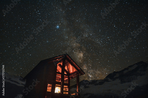 Alpine Log Cabin at Night Under the Starts and Milky Way 