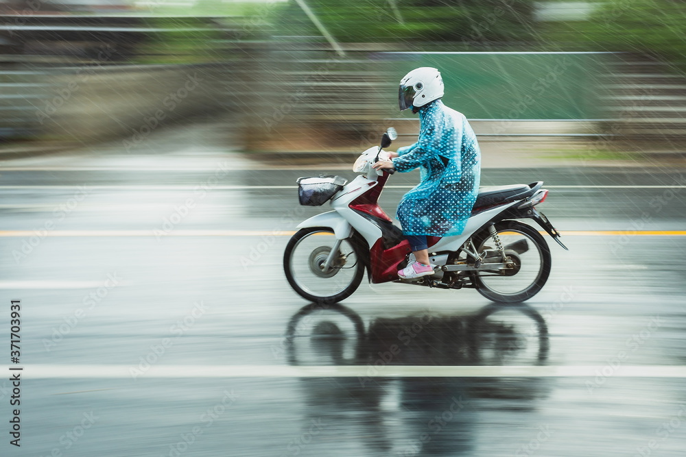 Motorcycle raincoat In the rain,people drive motorbike in rain day,motion blur of rush on running step,blur.;