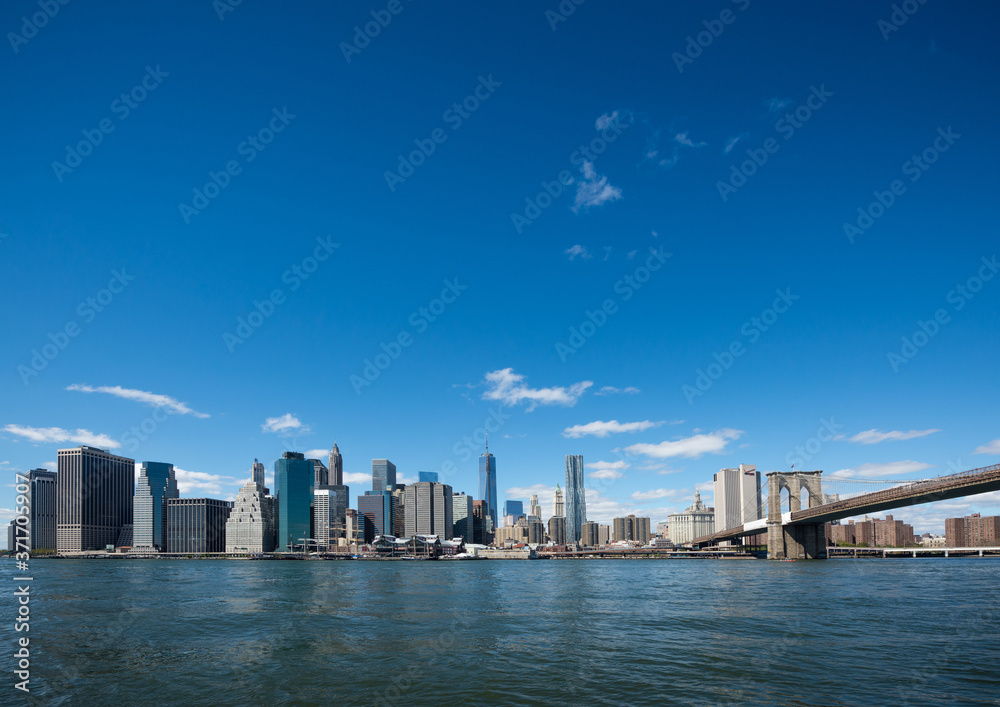 Brooklyn Bridge and Manhattan skyline in New York with blue sky