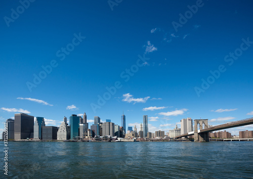 Brooklyn Bridge and Manhattan skyline in New York with blue sky