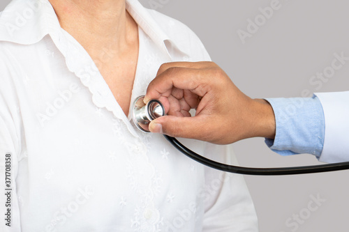 doctor using stethoscope to exam the woman patient who come to visit at hospital for sickness. healthcare and medical concept