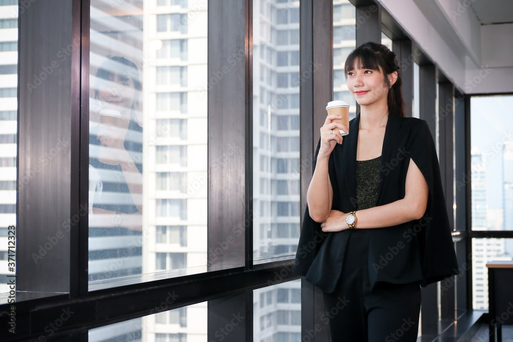 Business Lady officers or businesswoman smart posing standing while idea thinking with drink hot coffee in the morning in office Business Lady officers or businesswoman smart posing standing while idea thinking with drink hot coffee in the morning in office