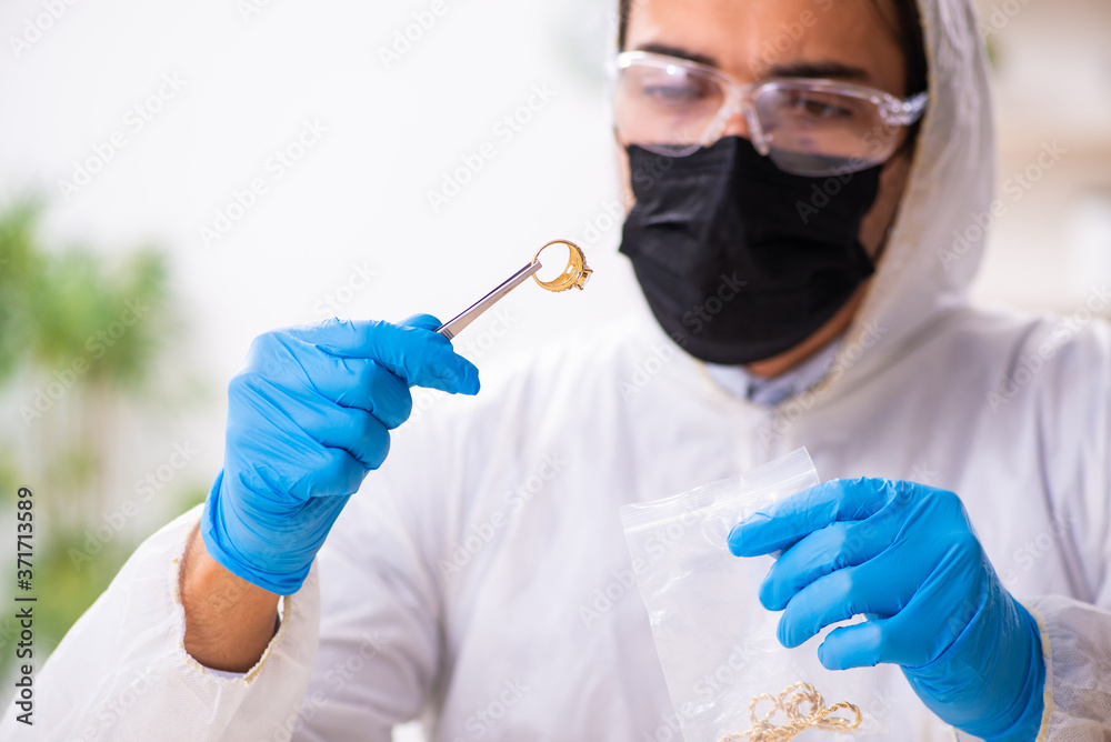 Male expert criminologist working in the lab for evidence Male expert criminologist working in the lab for evidence
