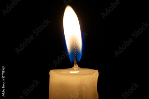 Burning candle with fire flame 