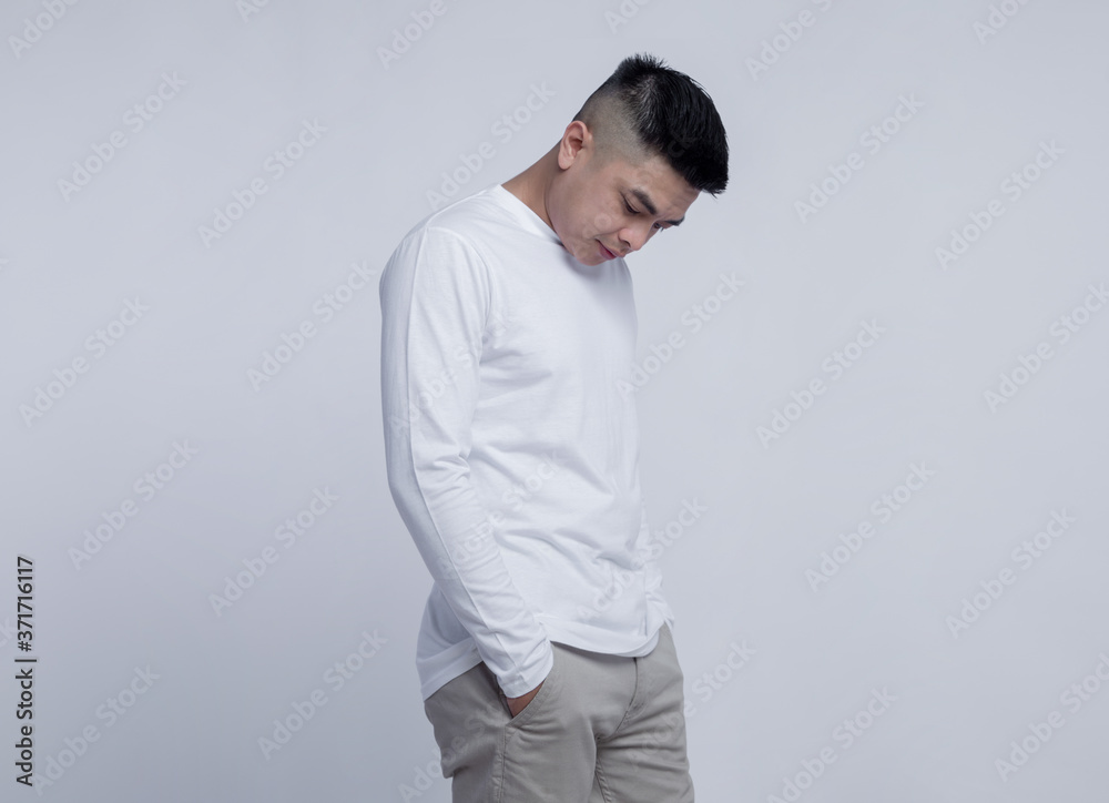 Young handsome man posing wearing white long sleeve t shirt with mockup concept Young handsome man posing wearing white long sleeve t shirt with mockup concept