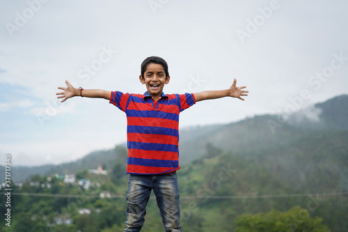 Portrait of a indian pahadi kid who belongs to the mountains. freedom and joy