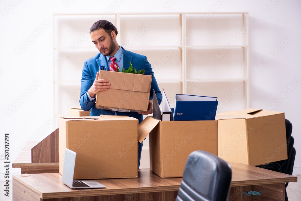 Young male employee in relocation concept Young male employee in relocation concept
