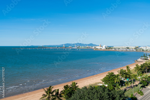 Beautiful tropical beach on The Strand, Townsville with the Port in the background © bellass