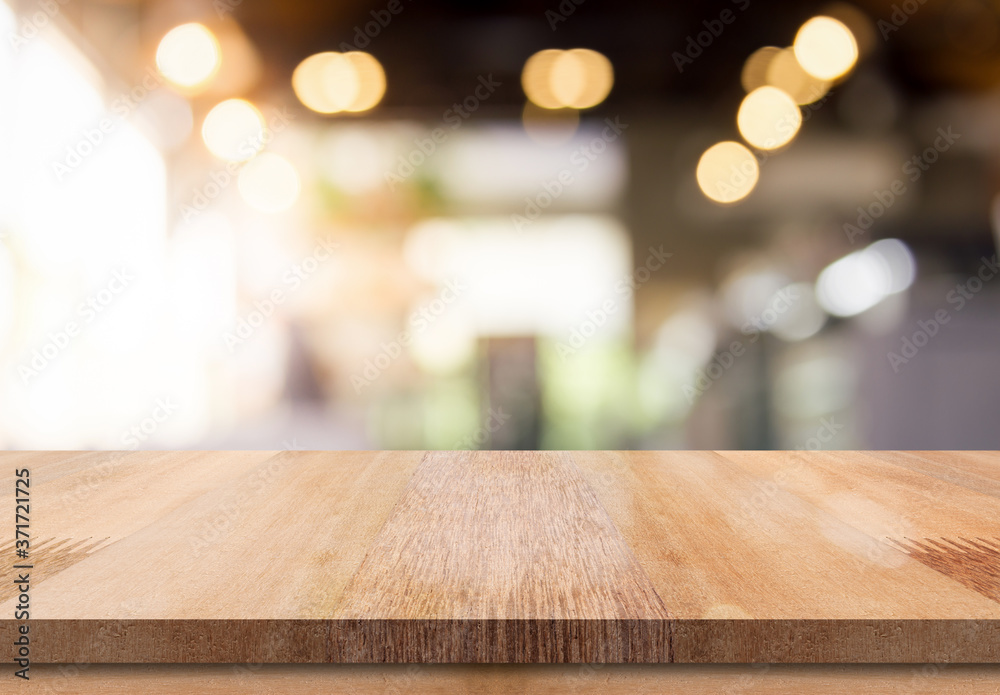 Empty wooden table top with lights bokeh on blur restaurant background