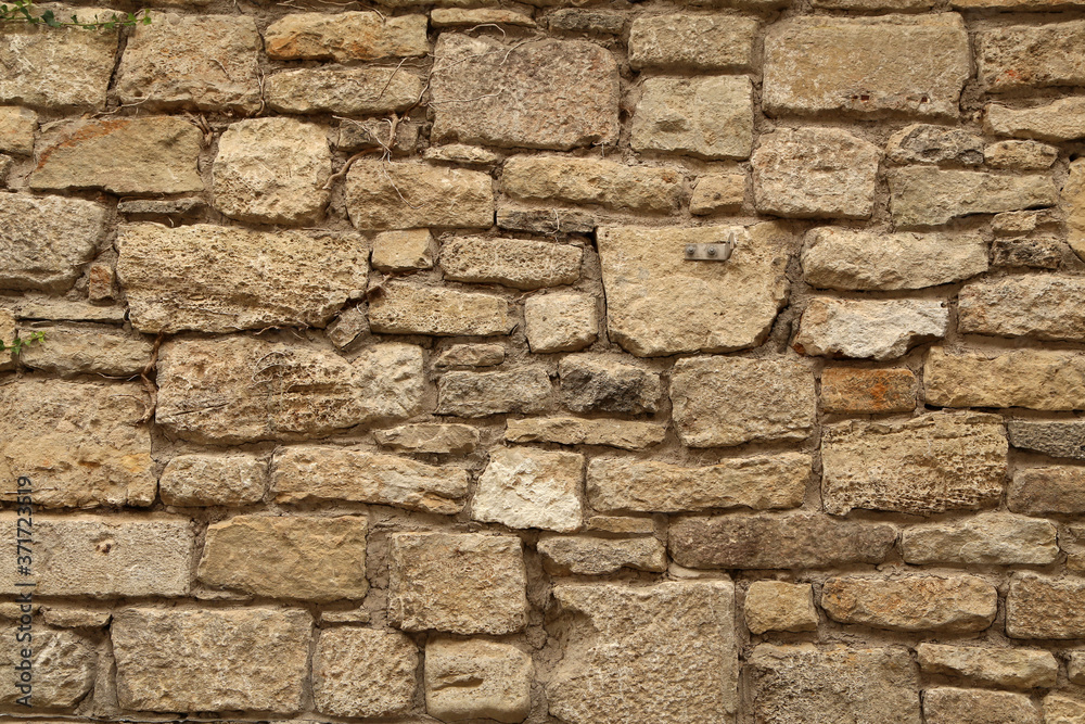 Obraz premium Gray stone wall made of natural stone