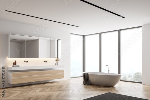 White bathroom corner with tub and sink