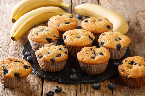 Homemade diet muffins with blueberries and bananas close-up on a slate board on the table. horizontal