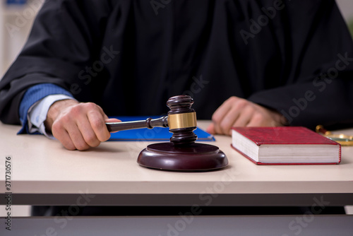 Young male judge working in courthouse