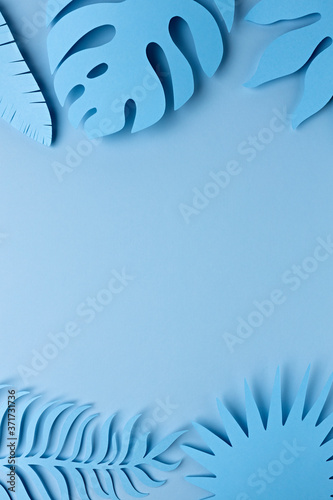 Tropical and palm leaves in blue bold gradient colors. Concept paper art. Minimal surrealism background. 