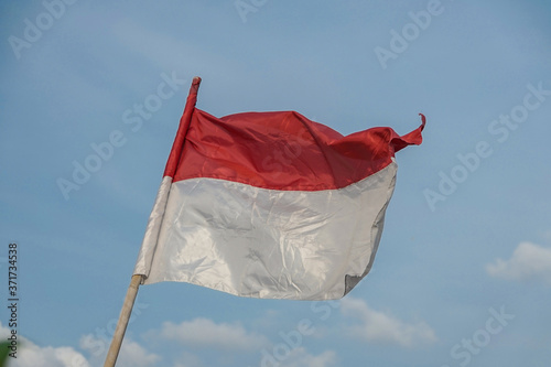 Inonesian flags flying with background sky. 