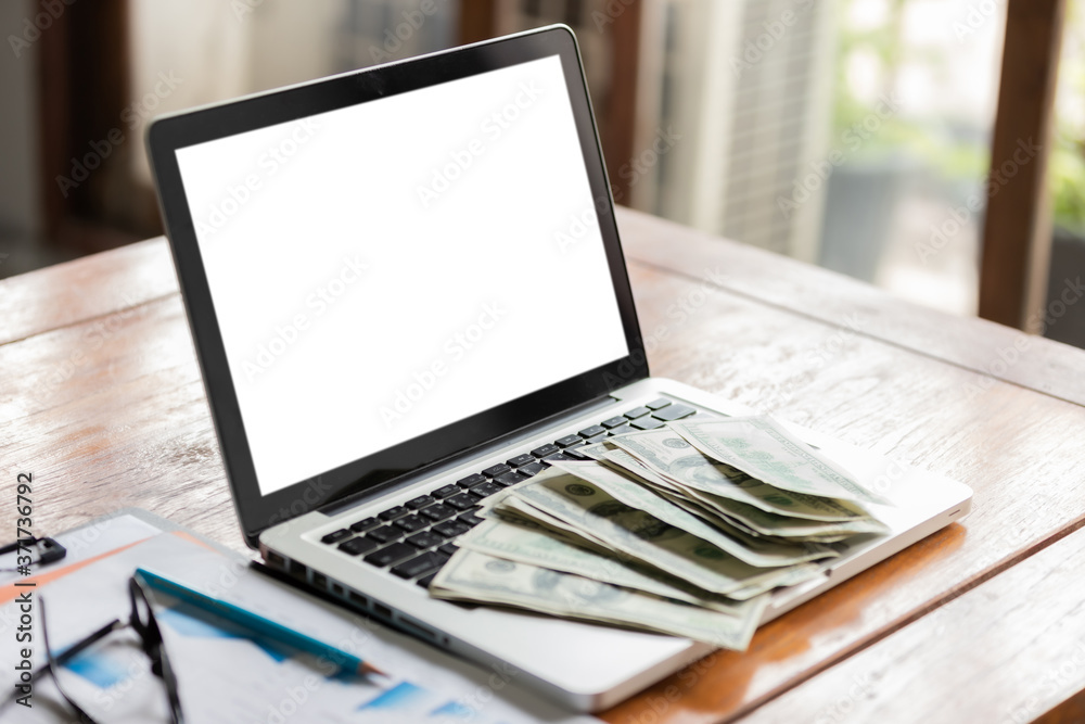 Office workplace with laptop and cash on wood table. Office workplace with laptop and cash on wood table.