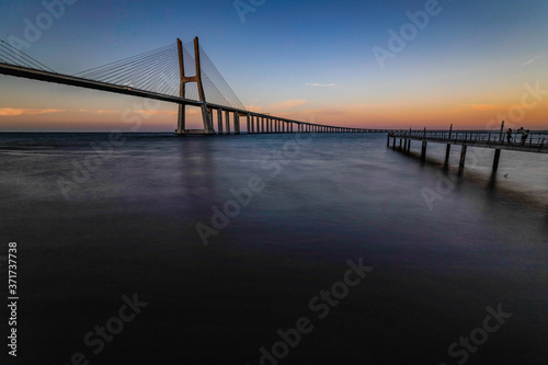 Fototapeta Naklejka Na Ścianę i Meble -  The Vasco da Gama Bridge is a cable-stayed bridge flanked by viaducts and spans the Tagus River in Parque das Nações in Lisbon, the capital of Portugal. It is the longest bridge in the European Union